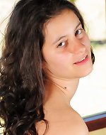 Full-bosomed brunette exposing her hairy armpits and pussy